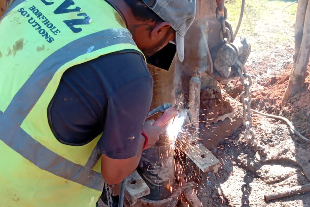EVZ Projects staff member preparing drilling equipment on site