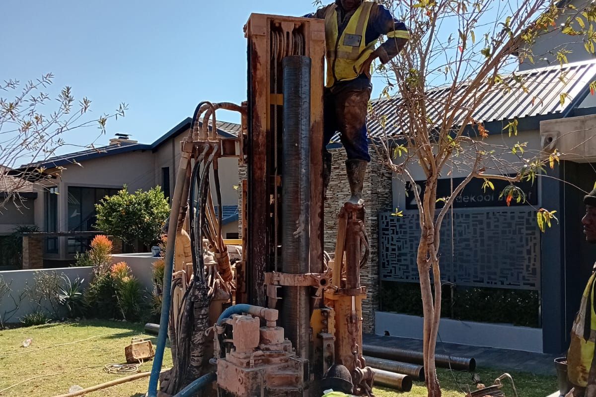 Borehole drilling rig in progress with EVZ Projects staff working on site