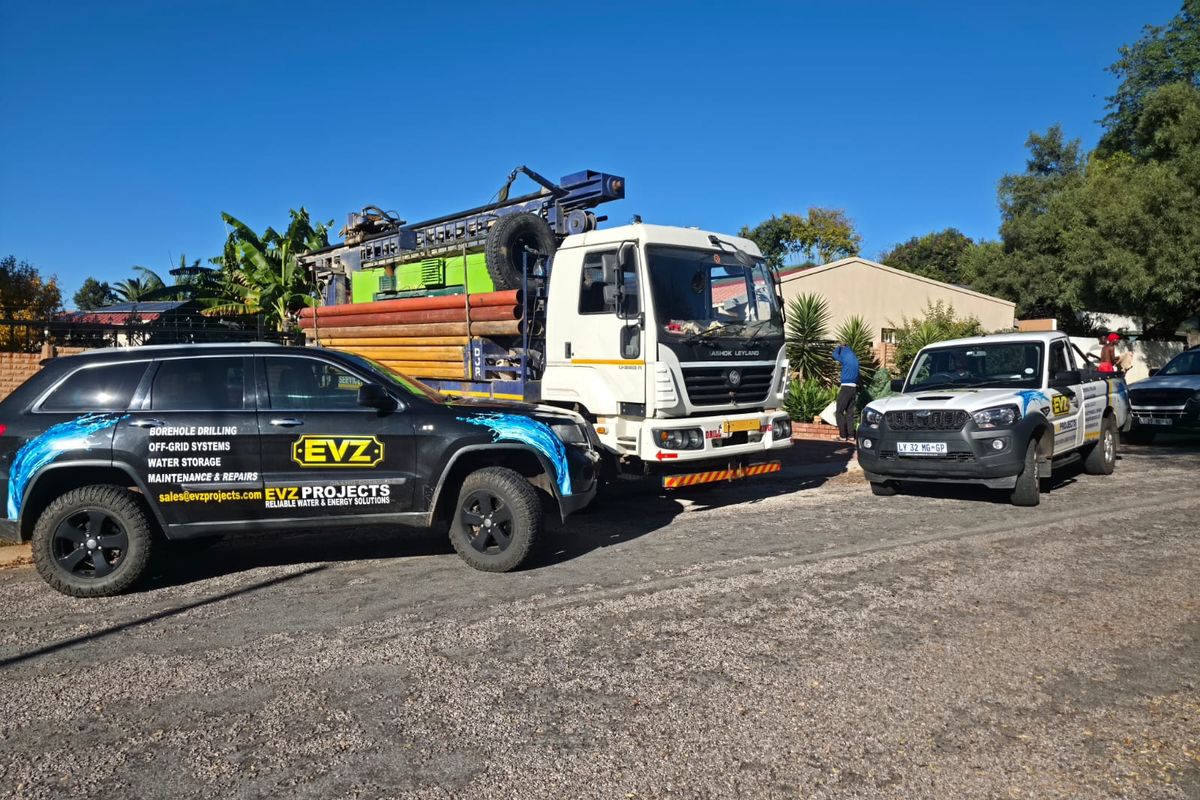 EVZ Projects branded vehicles and borehole drilling truck on site